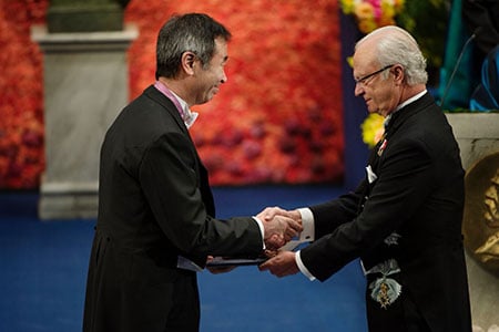 Takaaki Kajita  receiving his Nobel Prize from H.M. King Carl XVI Gustaf of Sweden