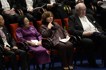 Nobel Laureates seated on stage. From left: Medicine Laureates Satoshi Åmura and Youyou Tu, Literature Laureate Svetlana Alexievich and Laureate in Economic Sciences Angus Deaton.