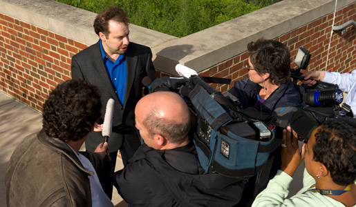 Adam Riess, 2011 Nobel Laureate in Physics, surrounded by reporters and news media outside Johns Hopkins University.