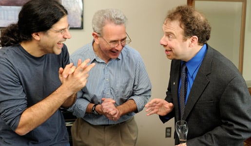 Adam Riess, right, is congratulated by colleagues after the announcement of the 2011 Nobel Prize in Physics
