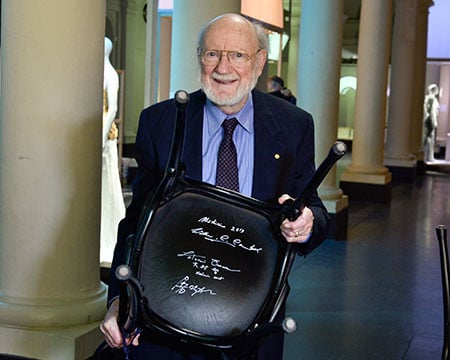 Nobel Laureate William C. Campbell and the autographed chair at the Nobel Museum in Stockholm.