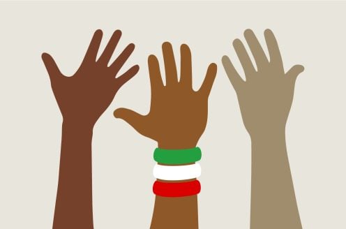 Three demonstrating hands. The hand in the middle wears a set of bracelets representing the colours of Iran.