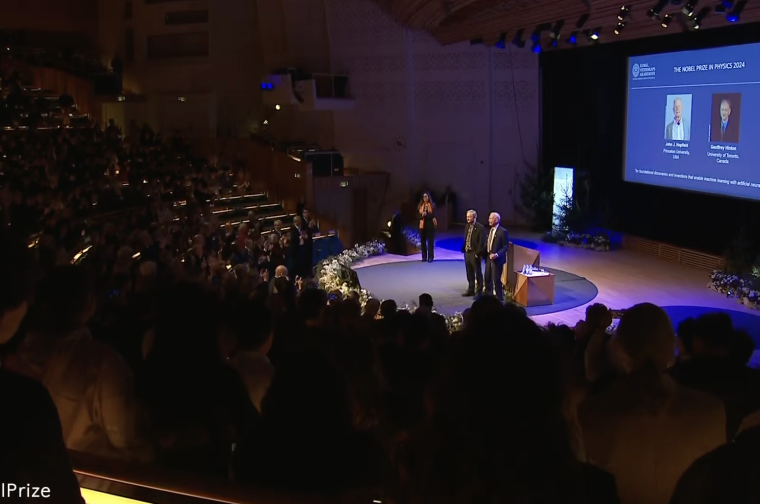 Audience applauding men on stage