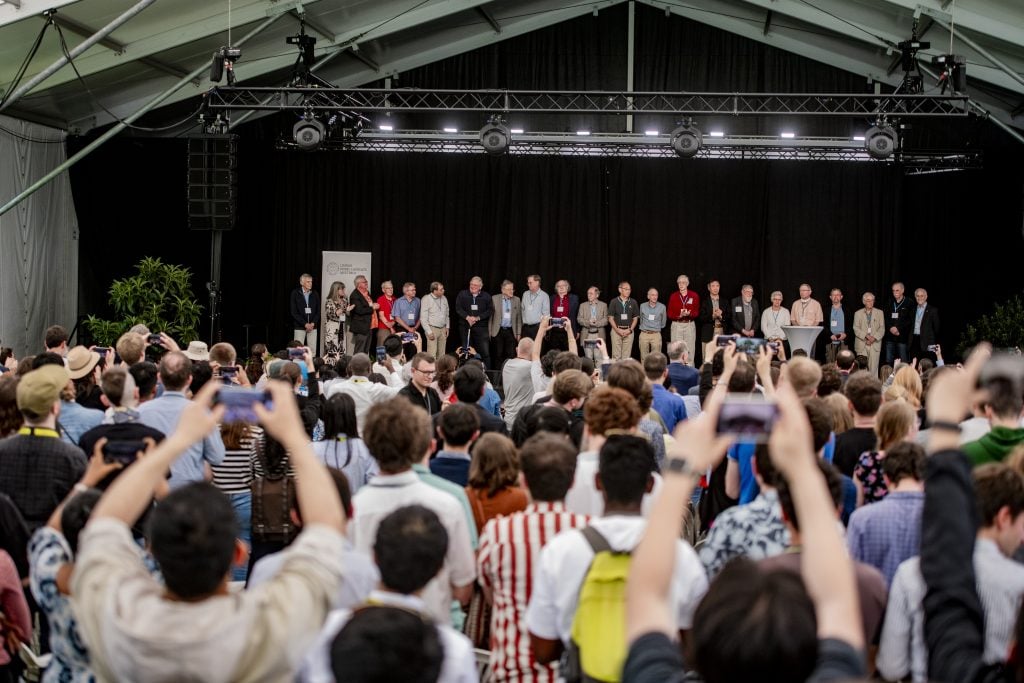 Group of people on stage in front of audience